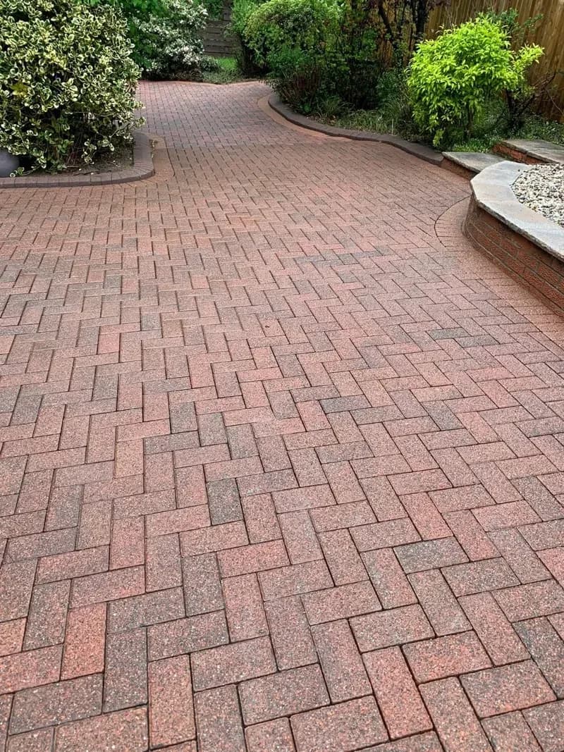 The same block paved driveway bright and completely moss free after a deep powerwash and re-sand