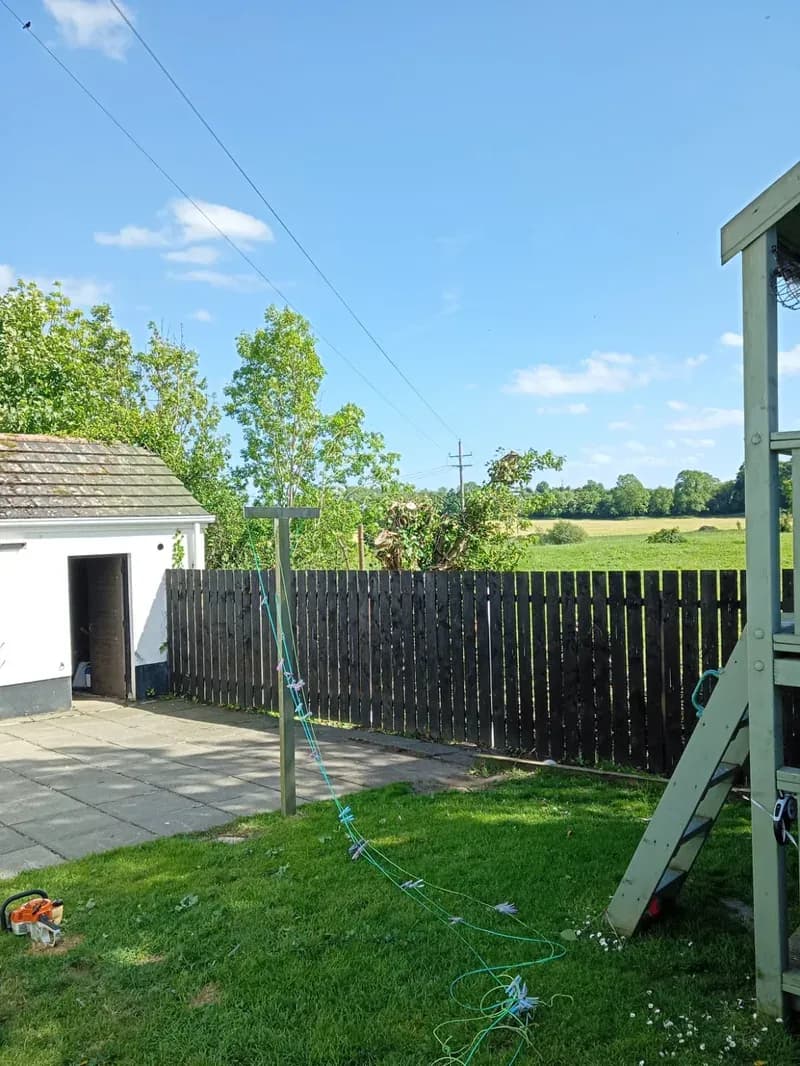 Back garden open to the sky and countryside after full tree removal and tidy up